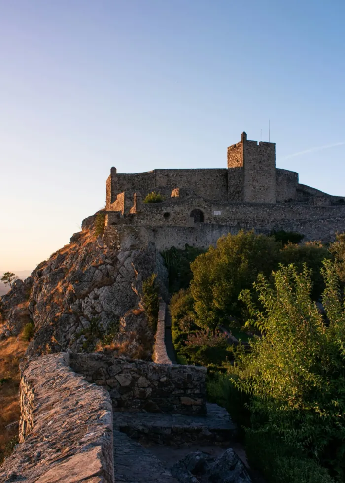 An Alentejo castle at sunset, above the plain.