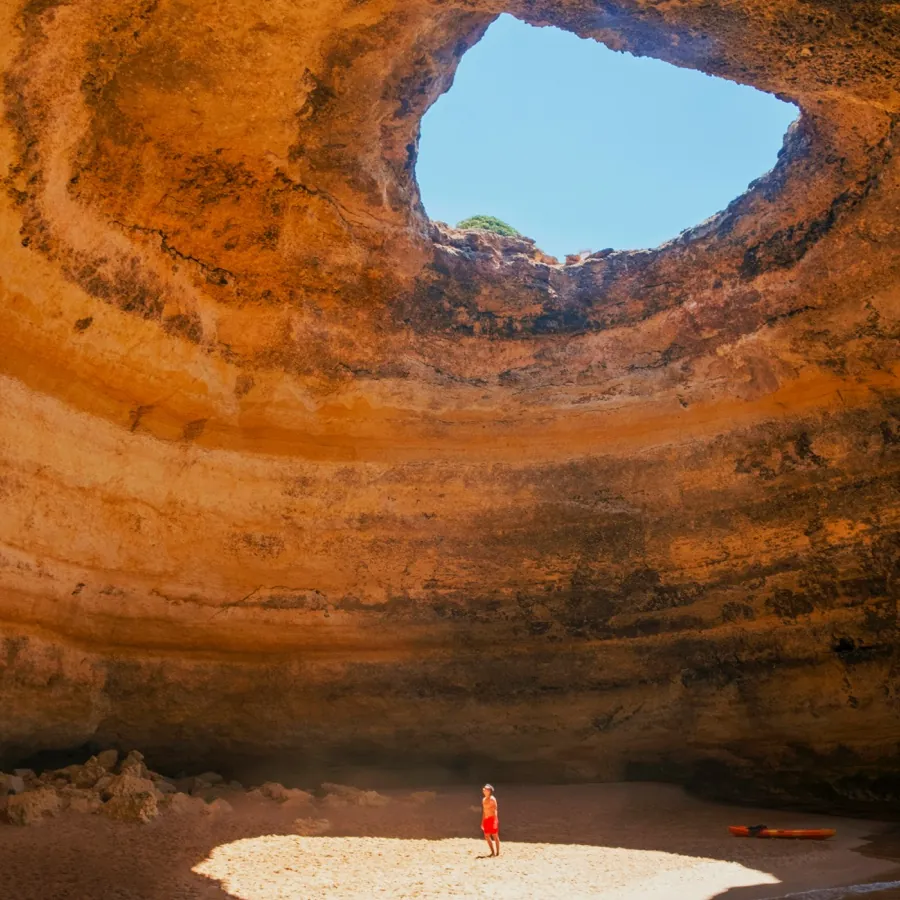 The Benagil sea cave seen from inside, open to the sky.